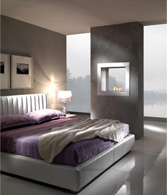 contemporary bedroom with large glossy floor tiles, brown walls, purple bedding and see-through gass fireplace free-standing wall