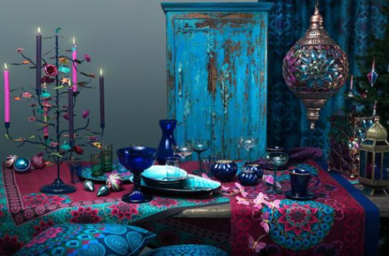 Bohemian style dining room with colourful weathered wood armoire and funky dishes
