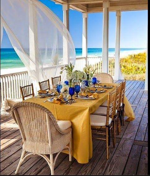 relaxed outdoor tablescape on sseaside verandah with flowing gauzy draperies