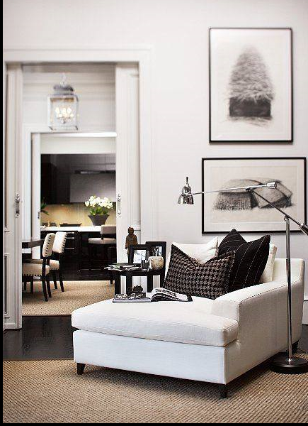 contemporary reading nook with large white chair and a half, black throw, chrome lamp, and sisal area rug