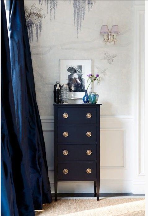 navy small dresser with navy silk draperies and floral wallpaper