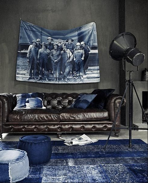 funky room with original art photo transfer in indogo , brown tufted leather sofa, and indigo area rug