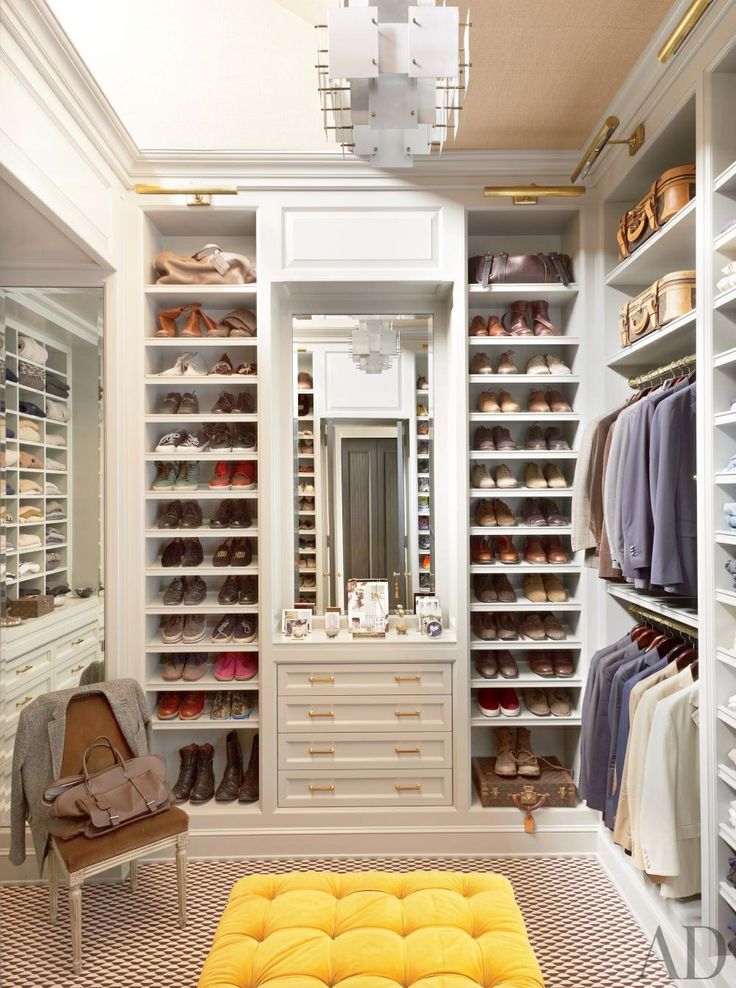 small bedroom built as a dressing room with three walls of floor to ceiling closet cabinetry