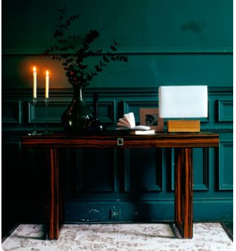 classic wood console table with dark emerald green-teal wall colour