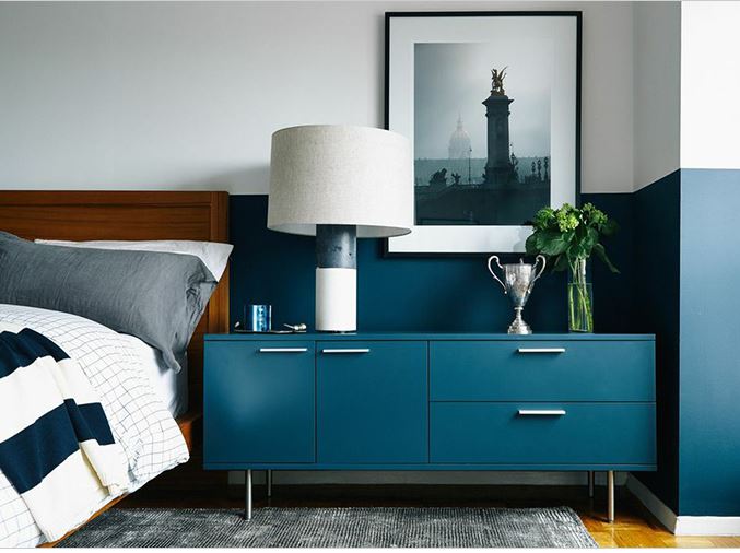 light and bright bedroom with teal dresser and matching colour blocked wall in teal