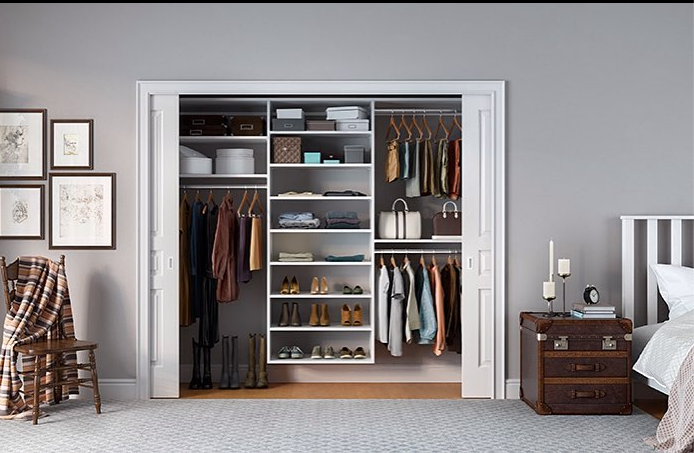 clean and organized bedroom closet with shelving in white