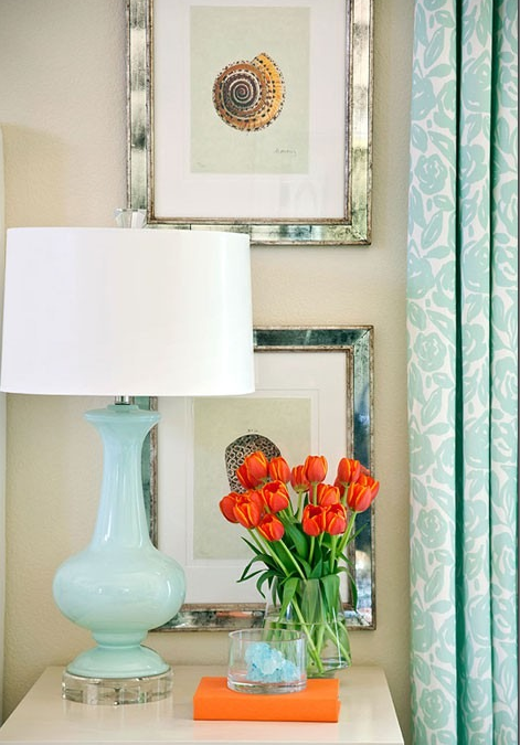 bedroom with aqua draperies and lamp with orange accents