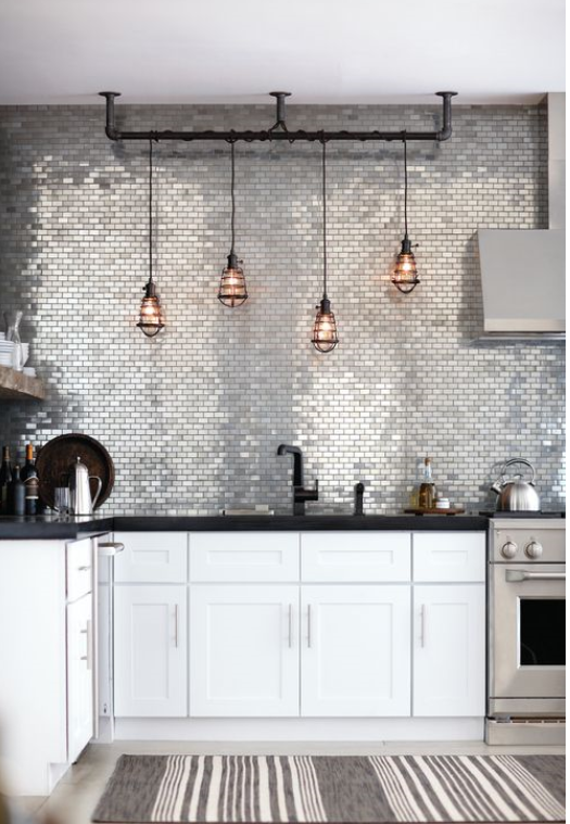 industrial chic kitchen with white shaker cabinetry and stainless small grey subway mosaic tile backsplash to the ceiling and bluch copper cage pendant lights