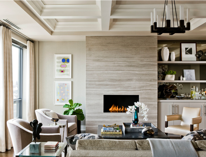 family room with slab stone fireplace with built-in cabinetry adjacent and custom draperies all in neutral colour palette