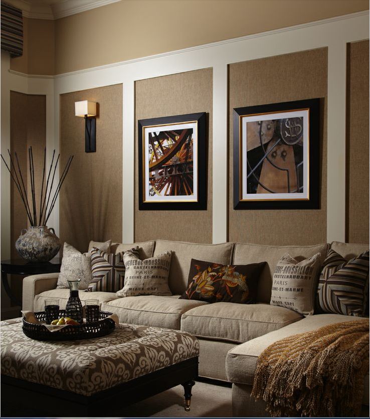 cozy family room with grass cloth panels, print ottoman, French toss cushions, and square shade wall sconces