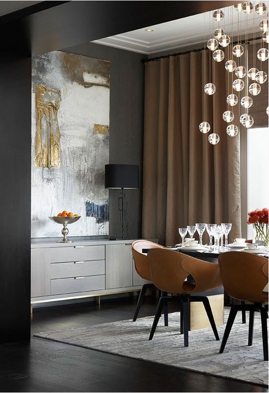 clean lined eclectic dining room with wrapped leather dining chairs, grey buffet, deep charcoal wall colour, and large abstract artwork in white, gold and blue