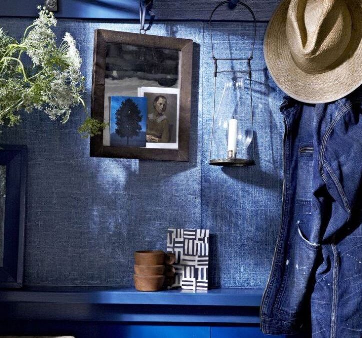 charming denim wall finish with hanging denim jacket, straw hat and lantern with candle