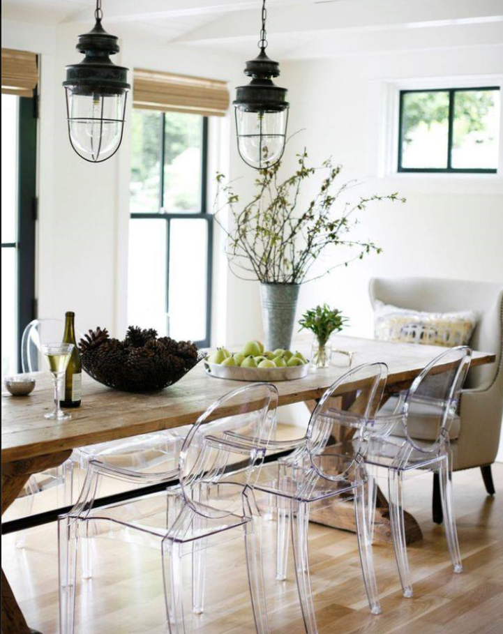 Casual upscale kitchen with reclaimed wood harvest table and clear acrylic chairs