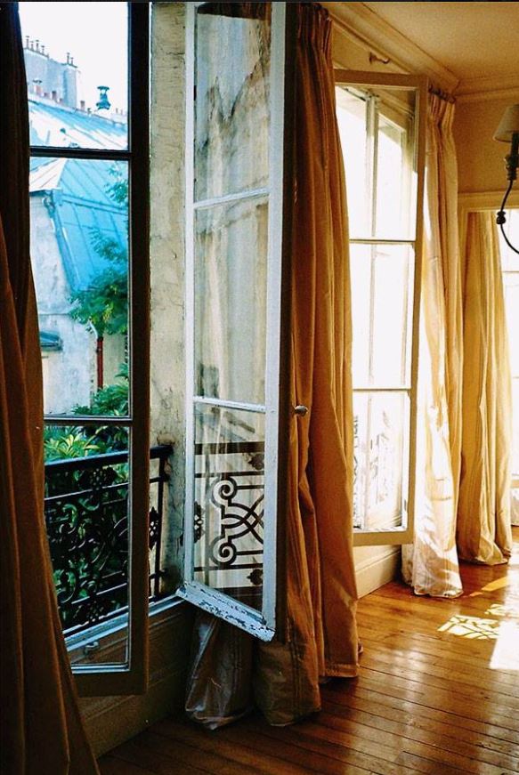 floor length custom silk draperies on tall open windows in French living room