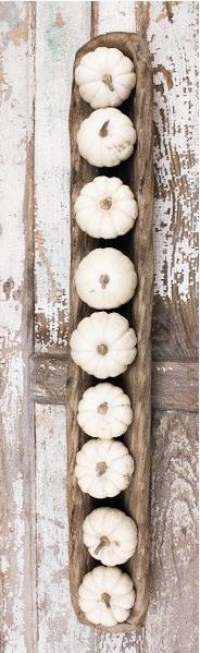 simple fall decor with small white pumpkins, wooden tray, and weathered table