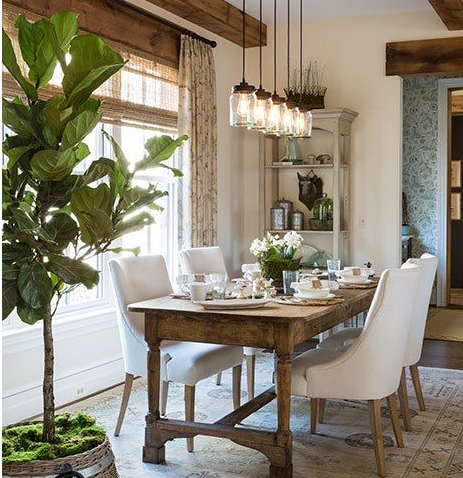 wide view of funky rustic upscale dining room with Hunter Douglas woven window blinds and weathered wood beams and dining table