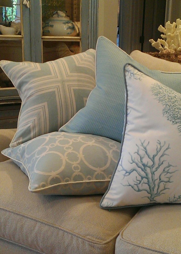 coastal style living room with pale twill weave sofa and soft blue and cream coastal motif toss cushions