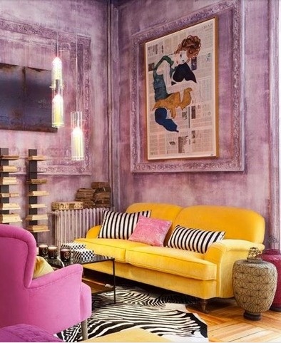 funky purple living room with rubbed wall treatment, yellow velvet sofa, pink armchair, zebra area rug, and lantern style lighting