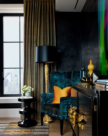 opulent living room with deep turquoise wing chair, navy wall colour, custom gold silk draperies, and black buffet and end table