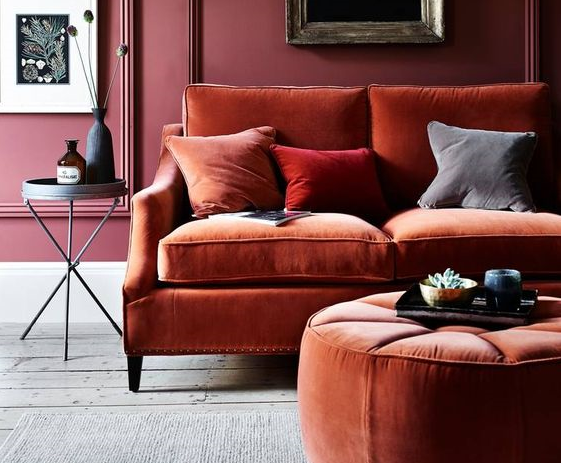 wide view of richly coloured deep orange and plum relaxed living room with comfortable rust s