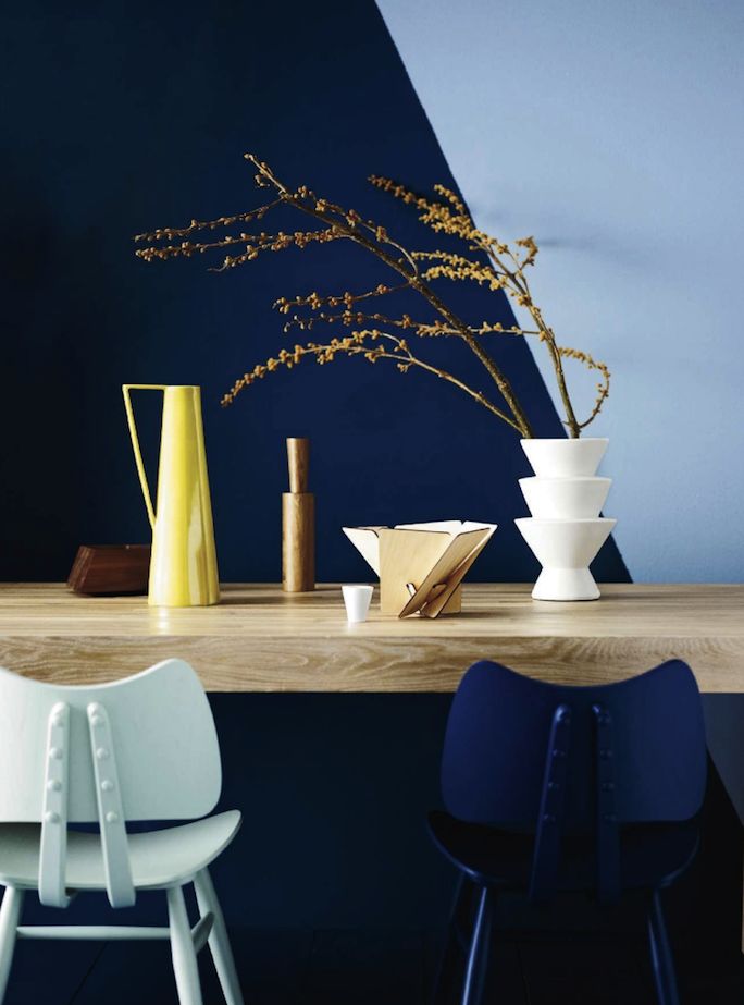 eclectic dining table with two-toned blue dramatic wall graphic