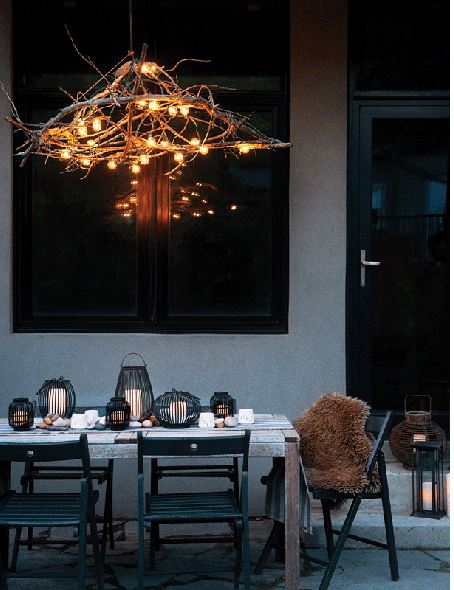 casual upscale outdoor tablescape with folding chairs, lanterns and twig chandelier