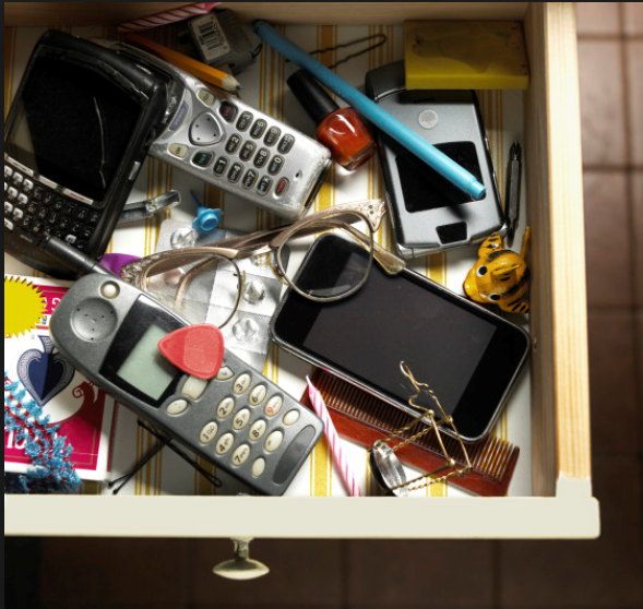 cell phone clutter in a drawer