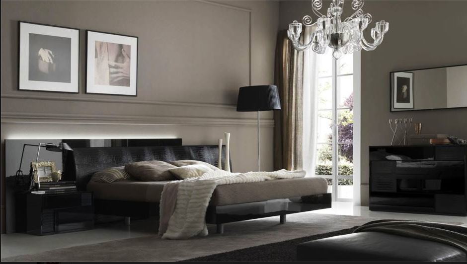 sophisticated master bedroom with black faux alligator headboard, black floor lamp, formal chandelier, paired artwork, and grey wall colour
