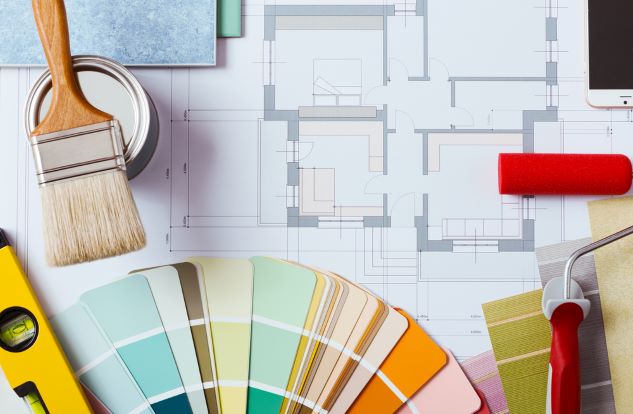 paint colour consultation accessories with paint brush, paint chip fandeck, paint roller, tile samples, and floor plan