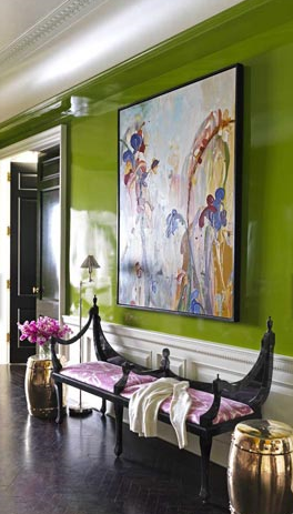 upscale foyer with dramatic, high gloss lime green wall colour, large abstract artwork, and unusual upholstered bench